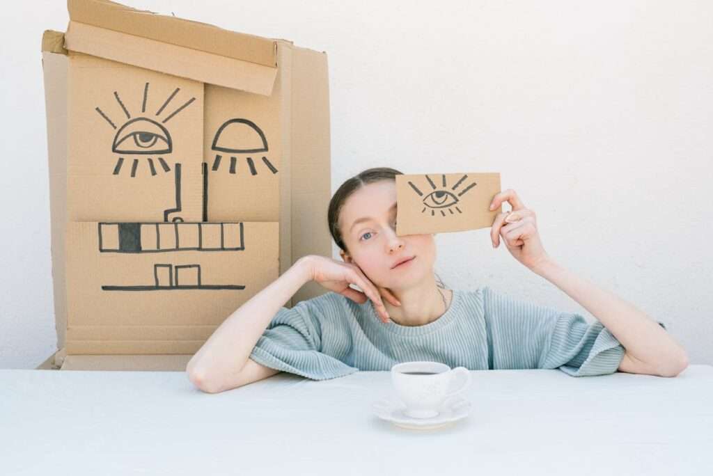 Woman Holding a Cardboard Box with a Drawing